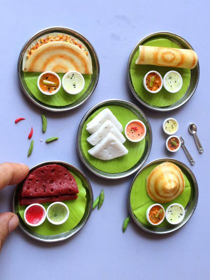 A collection of different dosa miniatures, including ragi dosa, neer dosa, and masala dosa.