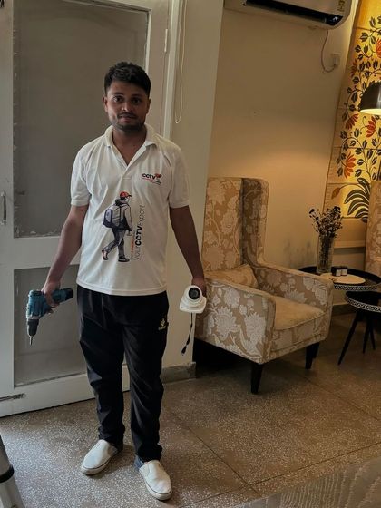 A successful indoor installation. My team member holds the tools of the trade and a newly installed camera, ready for the next task.