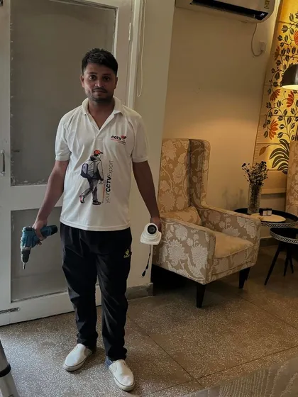 A successful indoor installation. My team member holds the tools of the trade and a newly installed camera, ready for the next task.
