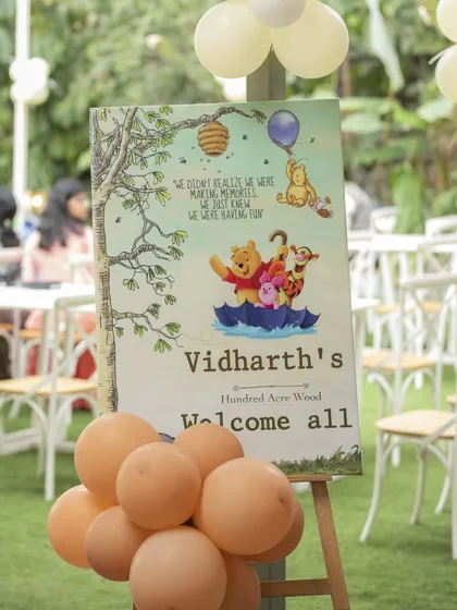 The welcome sign for Vidharth's party, featuring classic illustrations of Pooh and his friends. It's these little touches that create a warm and inviting atmosphere.