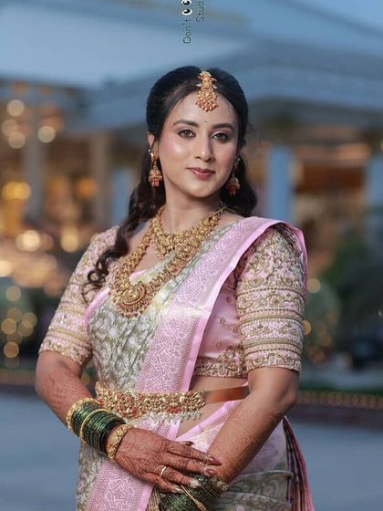 The complete reception look. The soft makeup and hairstyle pair beautifully with her elegant pink and silver saree.