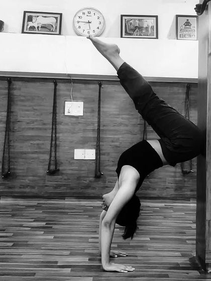 Using the wall is a fantastic tool for building confidence and strength in inversions. Here, I'm practicing a handstand variation to open the shoulders and work on my alignment before taking the pose to the center of the room.