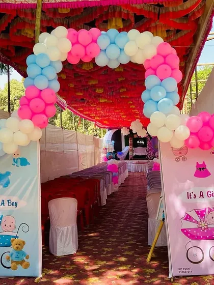The entrance to a baby shower with a double balloon arch in pink, blue, and white for a grand welcome.