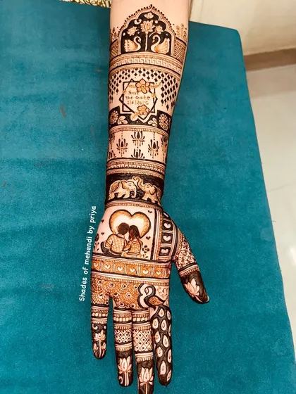 This full-arm design is a beautiful tapestry of love story elements. It includes a silhouette of a couple in a heart, elephants, swans, and a 'Save the Date' message.