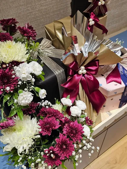 Another view of the Shoppers Stop and Axis Bank hamper, showcasing the rich color combination of burgundy, white, and gold. The arrangement is full and luxurious, designed to make a significant impact.