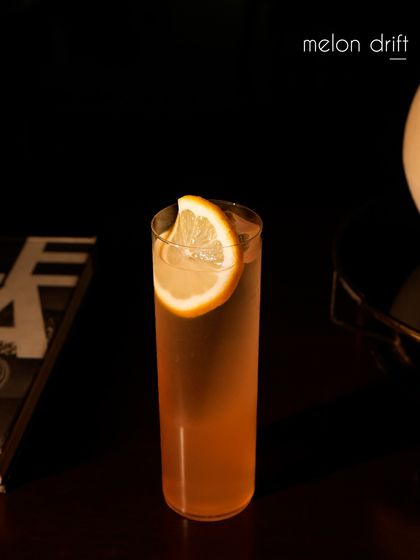Another view of our Melon Drift cocktail, a refreshing blend of 06 Rose Vodka, musk melon, and lime. Orange bitters and a saline solution enhance the fruit's flavor, creating a perfectly balanced and effervescent highball.