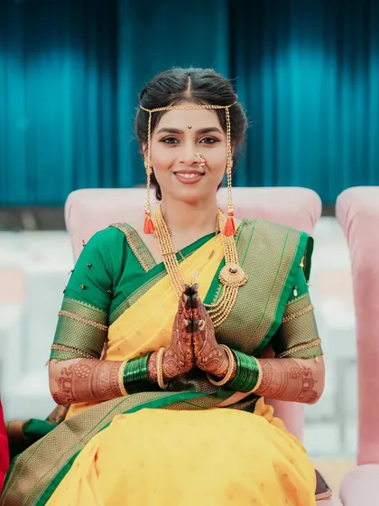 The bride's happy and blessed look during her pre-wedding rituals.