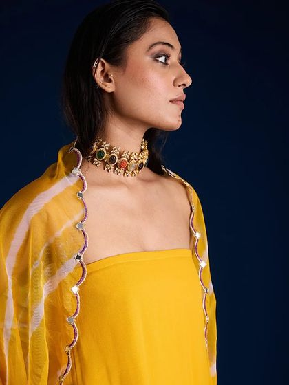 A close-up profile shot focusing on the jewelry and neckline details of the Aapro Alora Set.