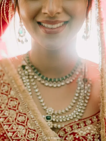 A close-up on a bride's smile and her magnificent multi-layered polki diamond necklace.