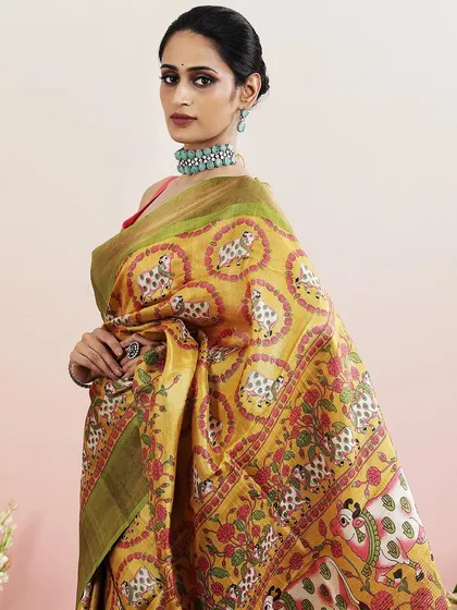 A close-up of the model wearing the Pichwai saree, paired with a statement choker.
