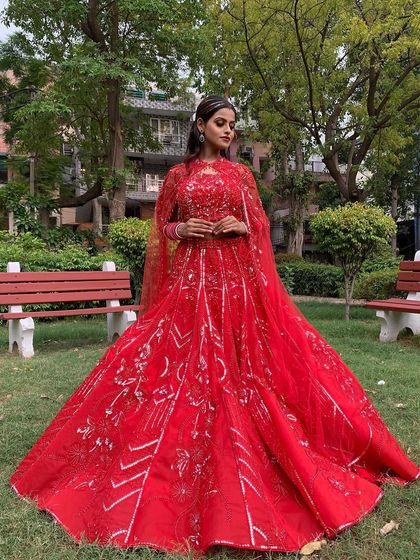 A full shot of the red lehenga with silver work, showcasing its impressive flare and modern design.