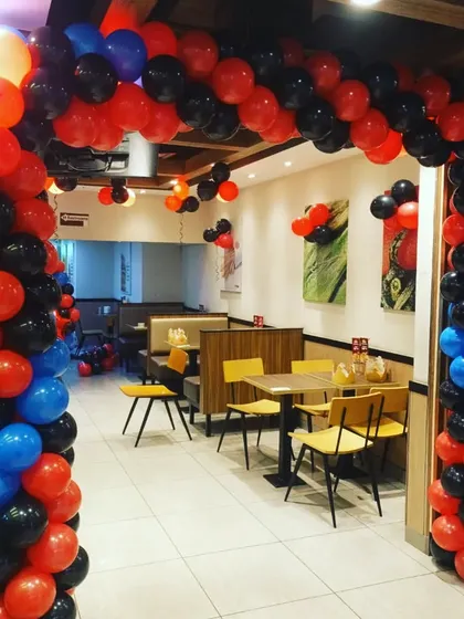 A balloon archway creating a grand entrance into the racing-themed party area.