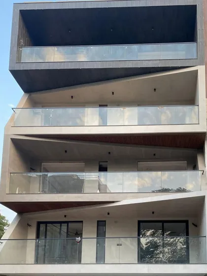 A direct frontal view of the Dwarka Sector 8 residence, emphasizing the dramatic angles and the interplay of solid and void across the different levels.