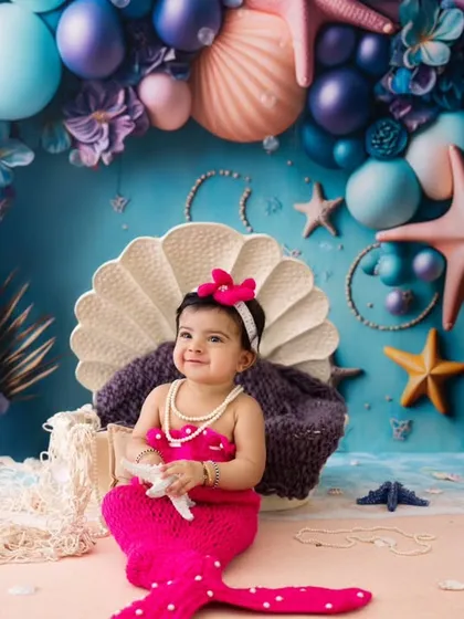 Look at this adorable little mermaid. This photo shows the fun and creativity of my fantasy-themed shoots, complete with a colorful under-the-sea backdrop and a custom mermaid tail outfit.