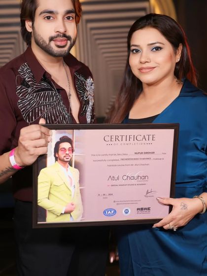 Presenting a certificate to a graduate. Her journey as a professional makeup artist starts now.