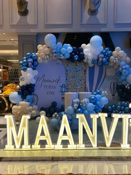 A sophisticated take on the hot air balloon theme for Maanvik's first birthday, using a palette of navy, baby blue, and beige.