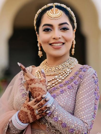 A stunning portrait of a bride, her intricate mehendi perfectly complementing her jewelry and makeup.