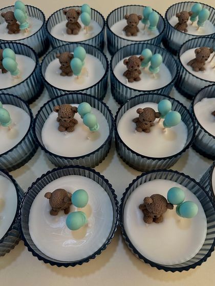 A batch of my elegant baby shower candles, featuring an adorable teddy bear with wax balloons. These are a customer favorite and can be customized in any color to match your theme.