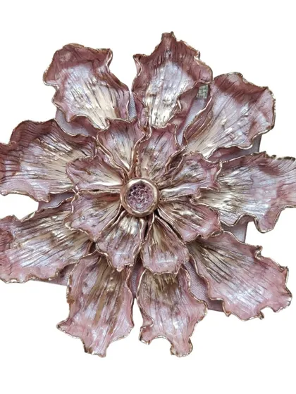 A single, large 3D flower sculpture with metallic pink and gold finishing. The petals are intricately layered and textured to catch the light, making it a stunning, standalone statement piece.