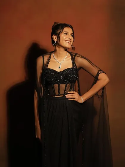 A happy and confident shot from a cocktail party. The clean makeup and elegant updo create a sophisticated look that is perfect for a family celebration.