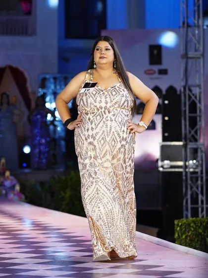 The same gold sequined plus-size gown from a different angle, showing its beautiful flow and shimmer.