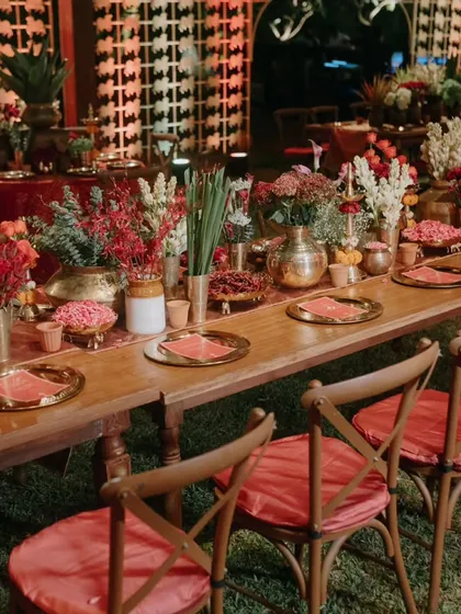Long community tables set for a reception, encouraging guests to mingle and celebrate together in a beautifully styled, rustic-chic environment.