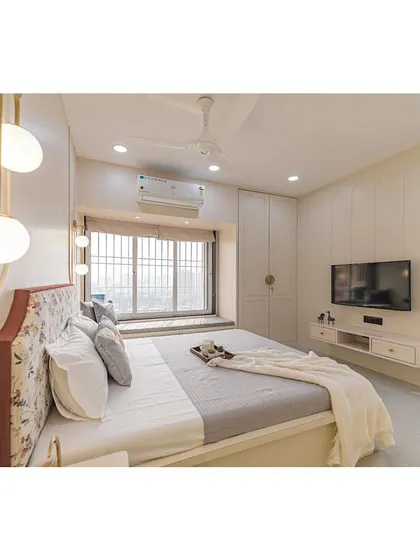 A wide view of the bedroom, highlighting the window seat and ample natural light. The design prioritizes comfort, simplicity, and ease of use.