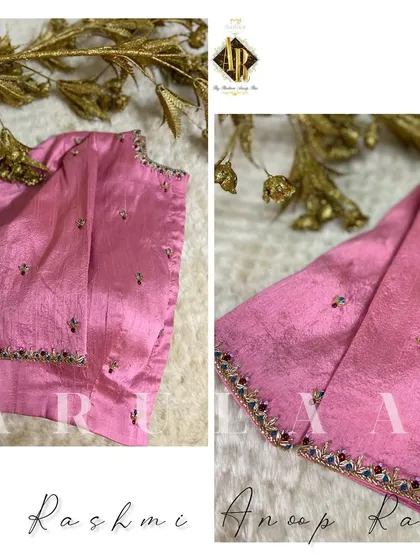 A closer look at the simple pink blouse, showing the minimal buti work and the delicate navratna-style border on the sleeve cuffs.
