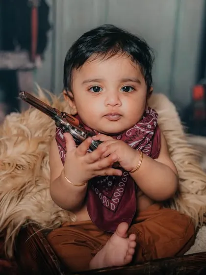 This little cowboy means business. Themed shoots like this are a great way to have fun and get creative with milestone photos.
