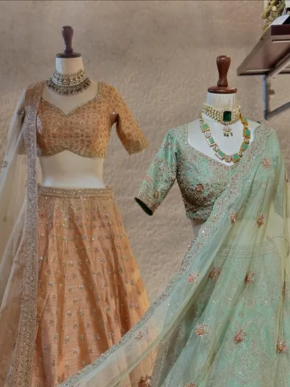 A view of both lehengas, emphasizing their flowing skirts and the cohesive yet distinct color palette, perfect for a bridal party.