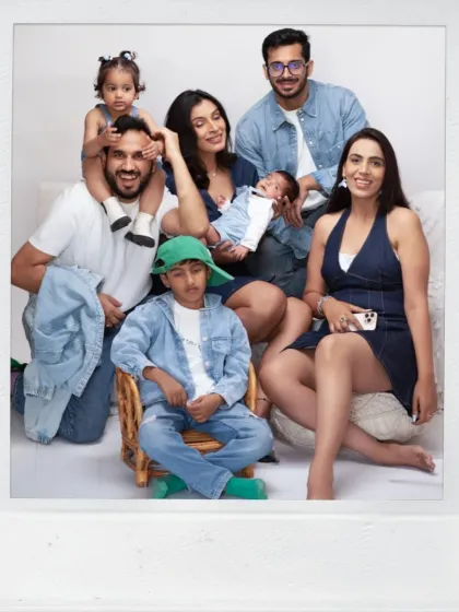 A large, happy extended family portrait. We welcome grandparents, aunts, and uncles to join in the photoshoot to capture the entire family's love.