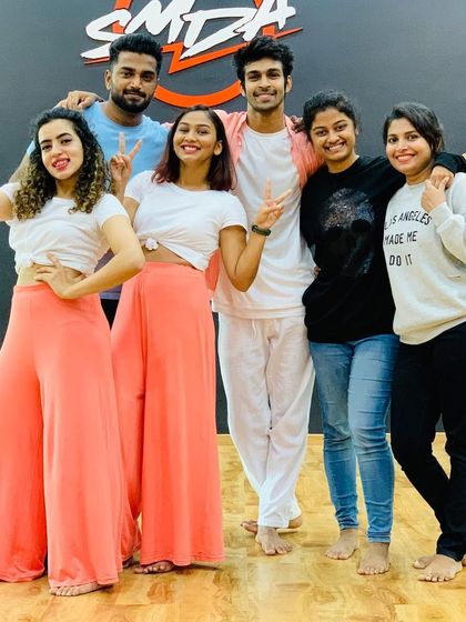 The whole team together after a successful shoot. We work closely with everyone involved to ensure the final performance is cohesive and full of positive energy.
