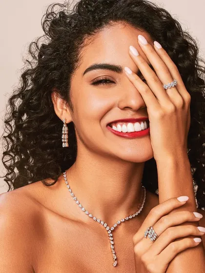 A classic beauty shot from a campaign for Aukera Jewellery. The focus here was on creating a joyful and radiant look with glowing skin, a bold red lip, and defined eyes that make the diamonds and the model's smile shine.