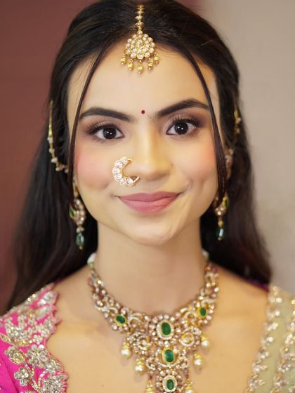 A beautiful, smiling portrait of Likitha. Her soft glam makeup, with its shimmering eyes and flushed cheeks, enhances her natural beauty and charm.