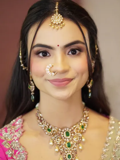A beautiful, smiling portrait of Likitha. Her soft glam makeup, with its shimmering eyes and flushed cheeks, enhances her natural beauty and charm.