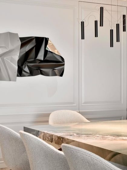 A closer view of the dining space, showing the harmony between my sculpture, the modern light fixture, and the elegant chairs.