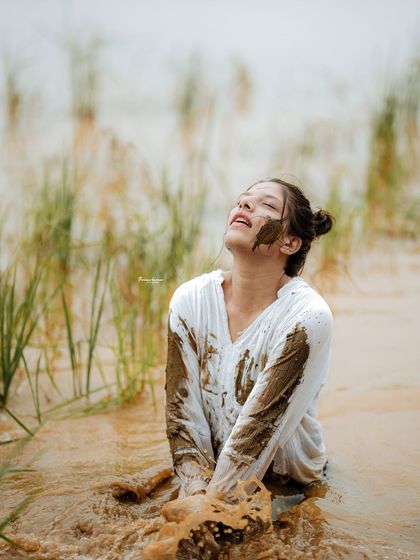 This shot combines the raw texture of mud with a sense of freedom and abandon. It's a perfect example of a high-concept fashion shoot.