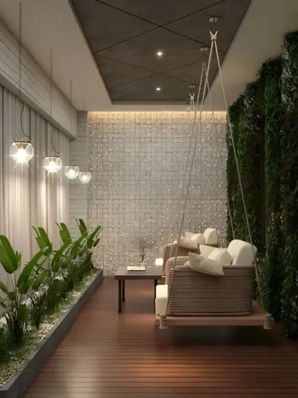 A beautiful wooden swing with comfortable cushions serves as the centerpiece of this long balcony. It's flanked by a lush vertical garden on one side and a planter bed on the other, creating a private, nature-filled nook for unwinding.