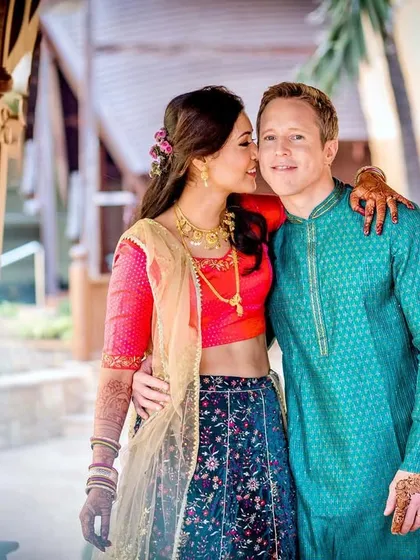 An adorable, candid moment as the bride whispers something to her partner. This shot captures the playful and intimate side of their relationship.