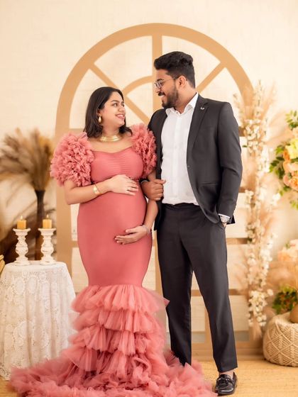 A classic couple's portrait in our boho studio, showcasing the elegant fit of the ruffled pink mermaid gown.