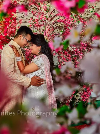 I love using creative framing to make a photo unique. Here, I shot through the floral decorations to create a dreamy, romantic portrait of the couple.