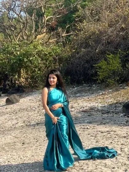 A pre-stitched saree is a fantastic option for pre-wedding shoots. This satin teal saree is easy to wear and creates a beautiful, flowing look.