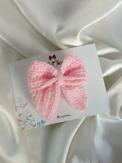 A close-up of our baby pink crochet Sailor Bow. The stitching is detailed and the shape is just perfect.