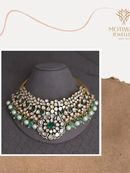 This grand bridal necklace is a masterpiece from my heritage collection, featuring uncut Polki diamonds and vibrant emeralds. It is designed for the bride who wishes to carry a piece of royal history on her most important day.