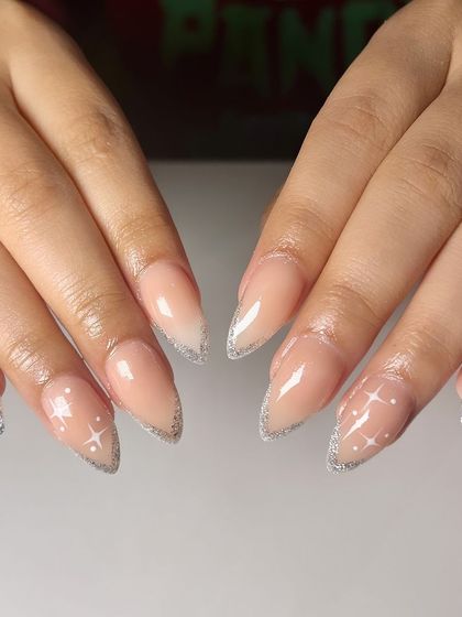 Elevate your French tips with a touch of sparkle and stardust. These glitter French nails with tiny star accents are perfect for adding a little magic to your day.