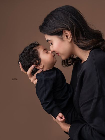 A tender moment between a mother and her baby, nose to nose.