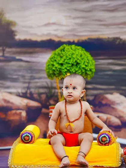A thoughtful portrait of the baby in our Swami Samarth setup, looking towards the side with a calm demeanor.