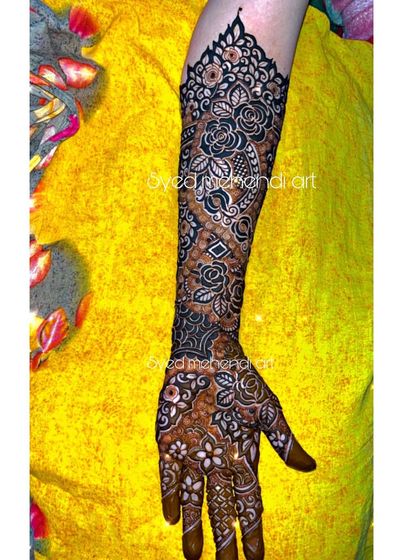 A single arm of a bridal design, showcasing the flow of patterns from hand to elbow.