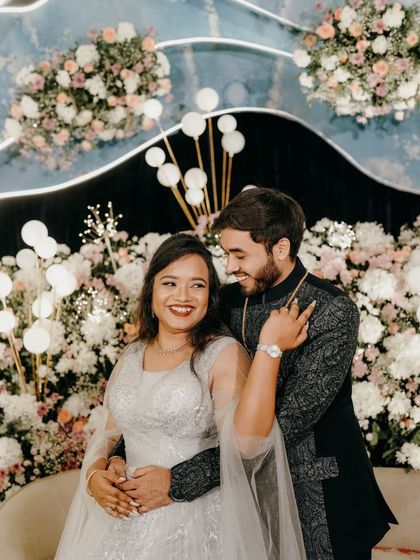 A joyful and candid portrait of the couple at their engagement party.
