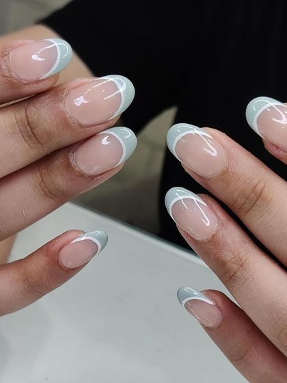 A cool and refreshing take on the French manicure with light blue tips and a delicate white accent line. This design is clean, simple, and effortlessly stylish.